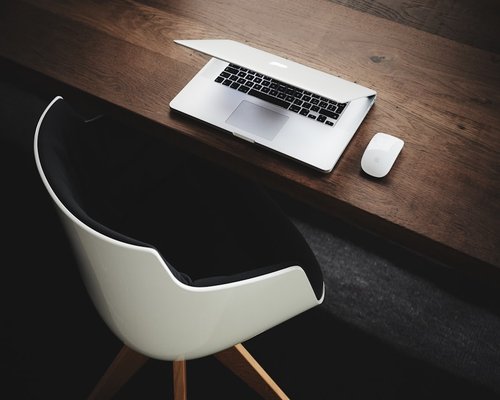 A clean domestic laptop setup structured with attention to physical alignment and ergonomic balance