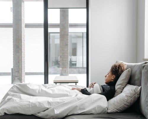 A peaceful brightly lit bedroom environment optimized for deep rest and mental recovery